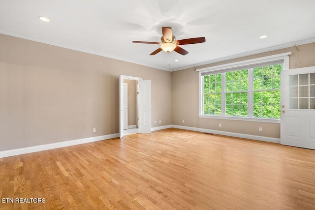 empty room with light wood-type flooring, crown molding, ceiling fan, and baseboards