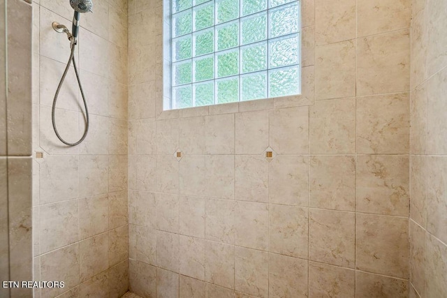 full bath featuring tiled shower