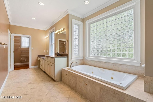 bathroom with a healthy amount of sunlight, vanity, a whirlpool tub, and ornamental molding