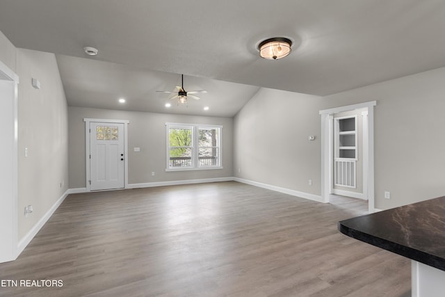 unfurnished living room featuring baseboards, a ceiling fan, wood finished floors, and recessed lighting