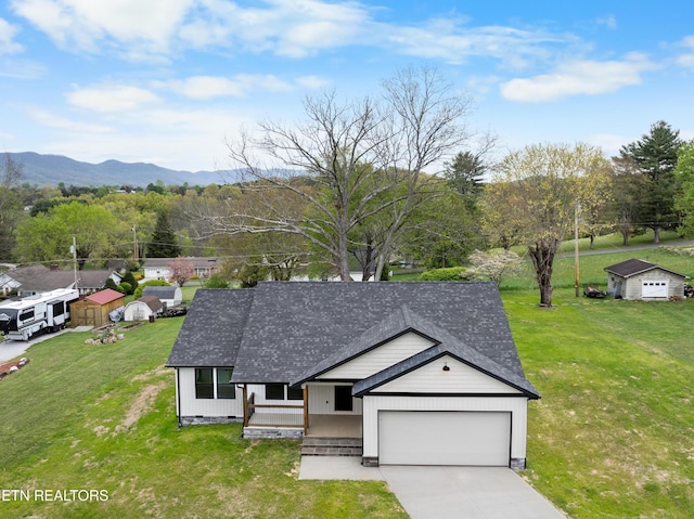 ranch-style house featuring an attached garage, a porch, roof with shingles, and concrete driveway