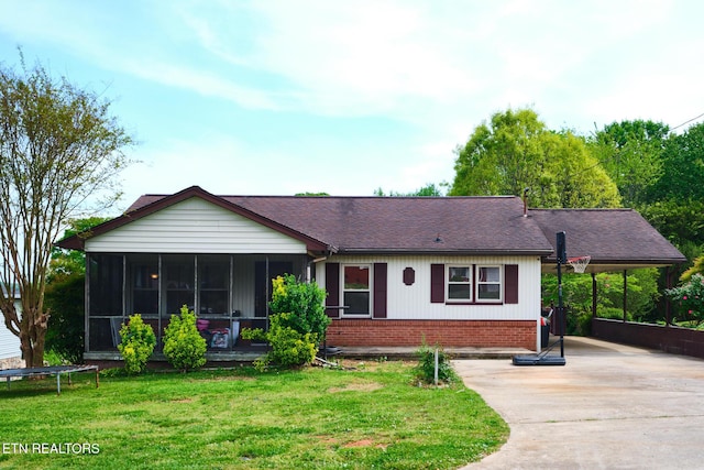 431 Mason Ln, Loudon, TN 37774 - single story home with a front lawn, a carport, concrete driveway, brick siding, and a sunroom