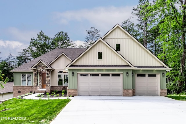 view of front of house with brick siding, driveway, a shingled roof, and a front yard
