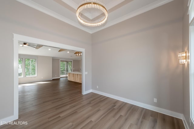 unfurnished room with baseboards, ornamental molding, dark wood-type flooring, and ceiling fan with notable chandelier