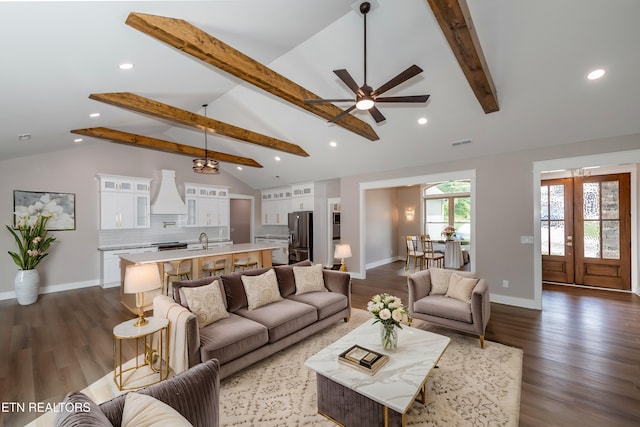 living room with baseboards, a ceiling fan, beam ceiling, and visible vents