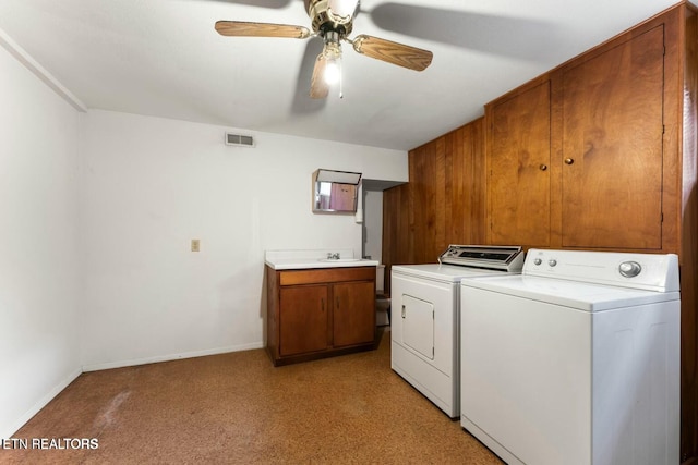 washroom featuring light carpet, visible vents, a ceiling fan, independent washer and dryer, and cabinet space