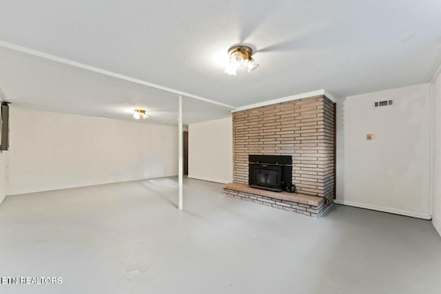 unfurnished living room with concrete floors, visible vents, and a fireplace
