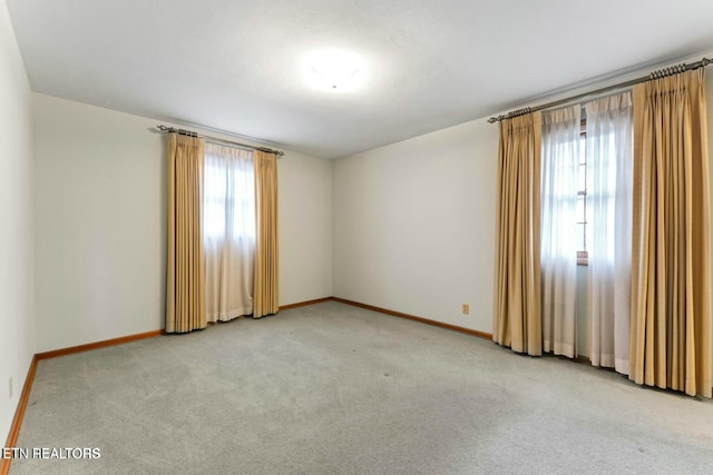 carpeted spare room with baseboards