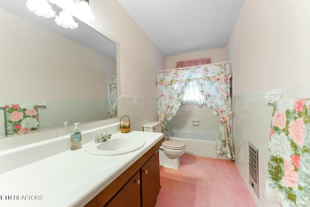 bathroom with toilet, tile walls, a shower, vanity, and a tub