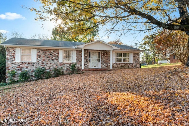 ranch-style house featuring brick siding