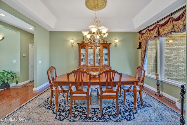 135 Austin Ln, Deer Lodge, TN 37726 - dining room with wood finished floors, visible vents, baseboards, and an inviting chandelier