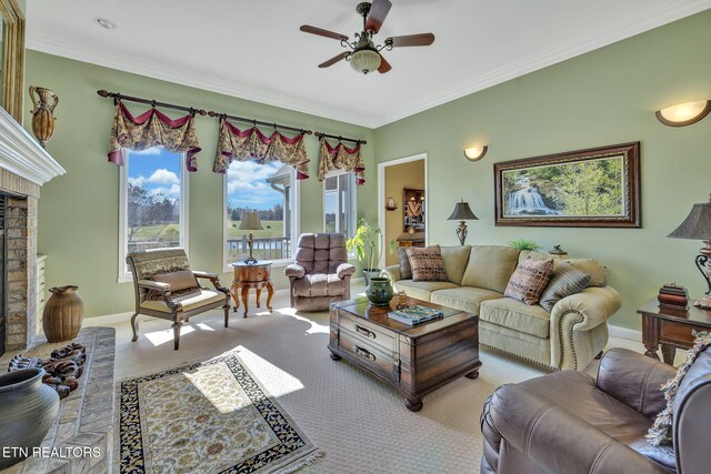 135 Austin Ln, Deer Lodge, TN 37726 - carpeted living room with a fireplace, crown molding, a ceiling fan, and baseboards