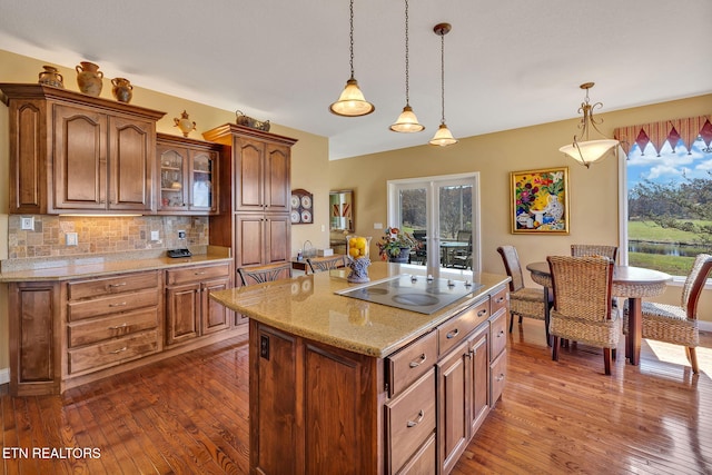 135 Austin Ln, Deer Lodge, TN 37726 - kitchen with dark wood-type flooring, backsplash, decorative light fixtures, and electric stovetop