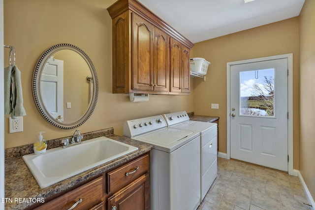 135 Austin Ln, Deer Lodge, TN 37726 - clothes washing area featuring stone finish floor, a sink, baseboards, washer and dryer, and cabinet space