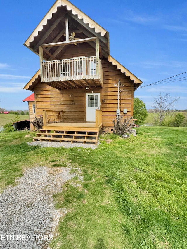 135 Austin Ln, Deer Lodge, TN 37726 - rear view of house with a yard, a deck, and a balcony