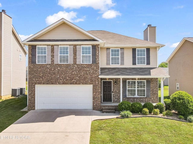 view of front of property with concrete driveway, a front lawn, and brick siding