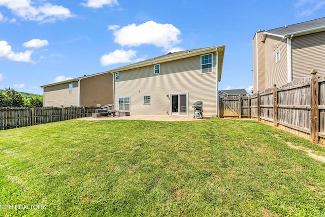 back of house featuring a fenced backyard, a gate, a patio, and a yard