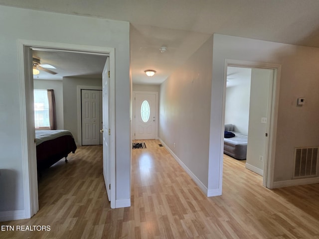 entryway featuring visible vents, light wood finished floors, baseboards, and a healthy amount of sunlight