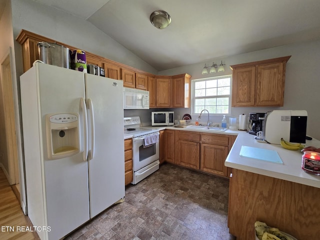 kitchen with light countertops, vaulted ceiling, a sink, and white appliances