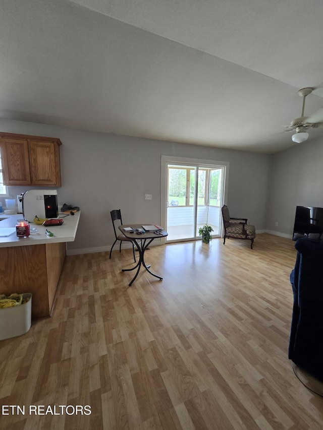 kitchen with light wood finished floors, baseboards, and brown cabinets