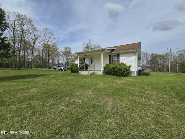 view of property exterior with a lawn and covered porch