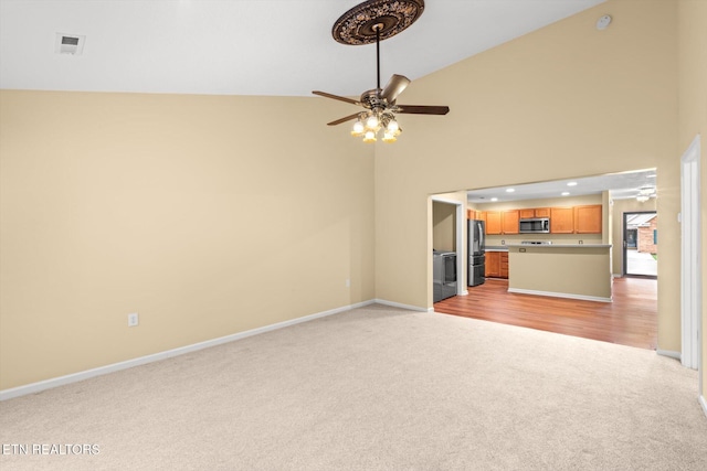 7143 La Christa Way, Knoxville, TN 37921 - unfurnished living room with high vaulted ceiling, baseboards, a ceiling fan, and light colored carpet