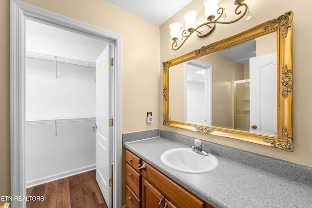 7143 La Christa Way, Knoxville, TN 37921 - full bathroom with vanity, wood finished floors, a spacious closet, and a shower with shower door