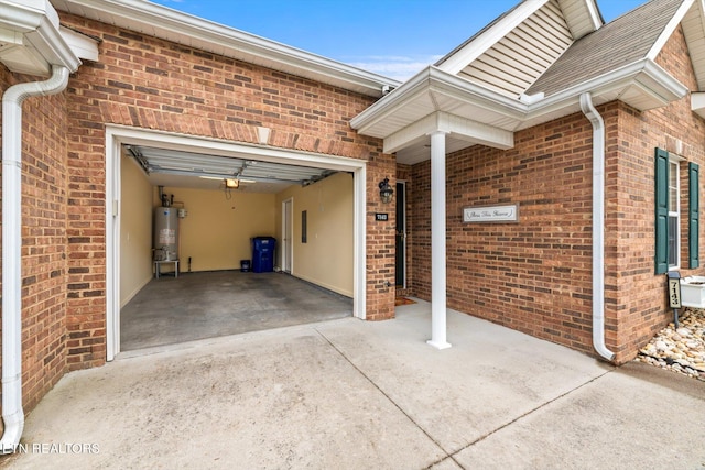 7143 La Christa Way, Knoxville, TN 37921 - view of side of home with brick siding, an attached garage, water heater, and concrete driveway
