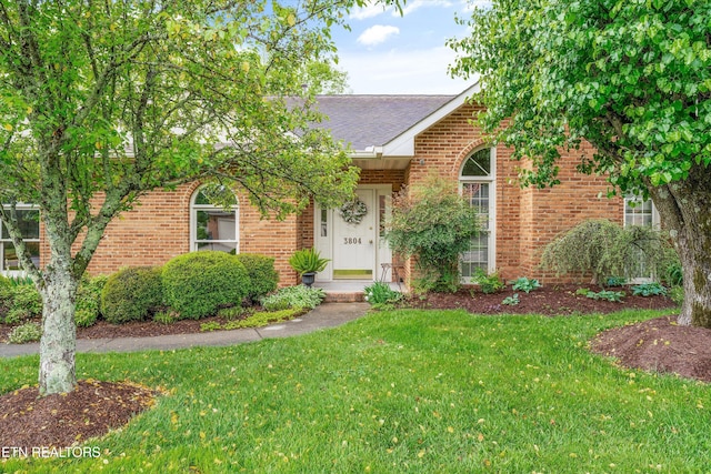 3804 Whitworth Dr, Knoxville, TN 37938 - view of front of property featuring brick siding, a shingled roof, and a front yard