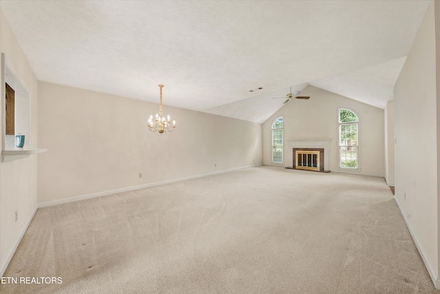3804 Whitworth Dr, Knoxville, TN 37938 - unfurnished living room with ceiling fan with notable chandelier, baseboards, lofted ceiling, and light colored carpet