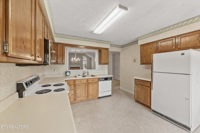 3804 Whitworth Dr, Knoxville, TN 37938 - kitchen with light countertops, a sink, white appliances, brown cabinetry, and a notable chandelier