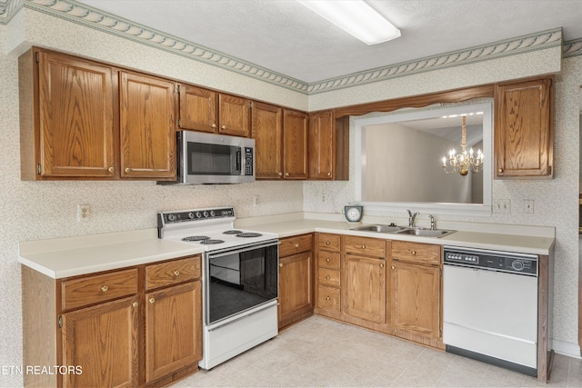 3804 Whitworth Dr, Knoxville, TN 37938 - kitchen featuring light countertops, a sink, white appliances, a chandelier, and brown cabinetry