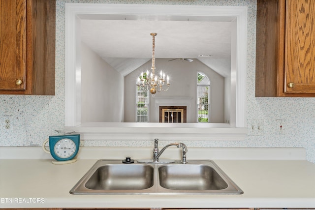 3804 Whitworth Dr, Knoxville, TN 37938 - kitchen featuring a sink, wallpapered walls, brown cabinets, light countertops, and lofted ceiling