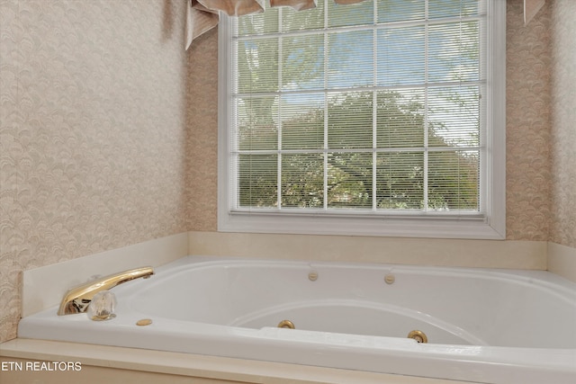 3804 Whitworth Dr, Knoxville, TN 37938 - bathroom with a tub with jets, wallpapered walls, and plenty of natural light