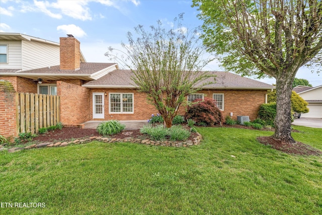 3804 Whitworth Dr, Knoxville, TN 37938 - view of front of house with brick siding, a front lawn, a chimney, and fence