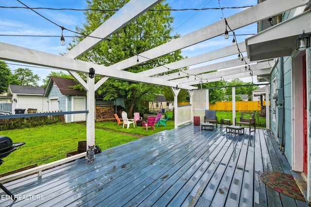 wooden deck featuring a lawn, fence, an outdoor structure, and a pergola