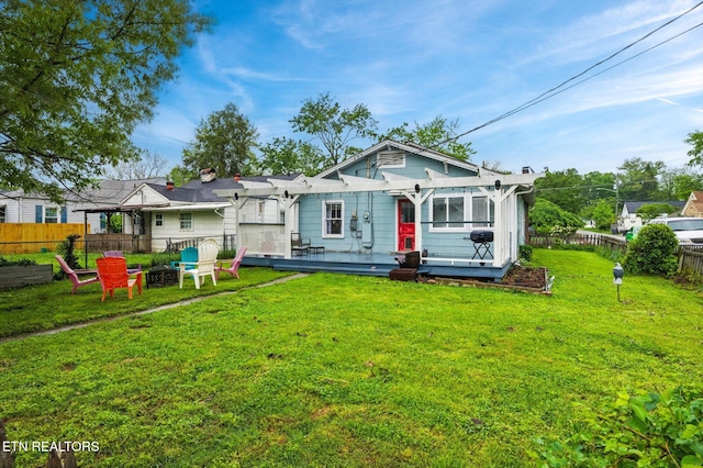 back of property featuring a deck, a fire pit, a fenced backyard, and a pergola