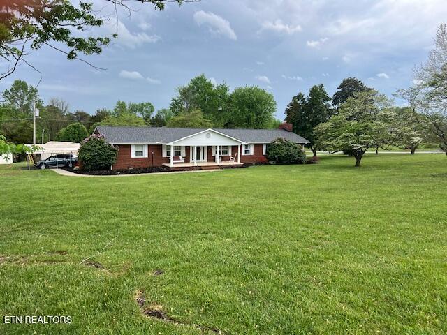 205 Hickory Ln, Jacksboro, TN 37757 - single story home featuring covered porch and a front lawn