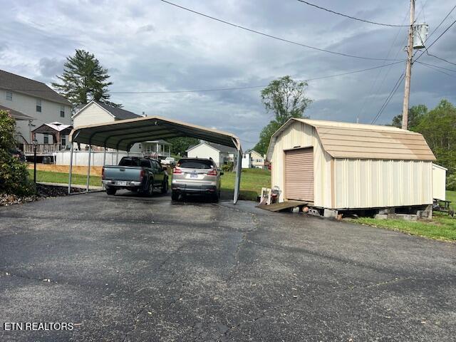 205 Hickory Ln, Jacksboro, TN 37757 - view of vehicle parking with a storage shed, a detached carport, and aphalt driveway