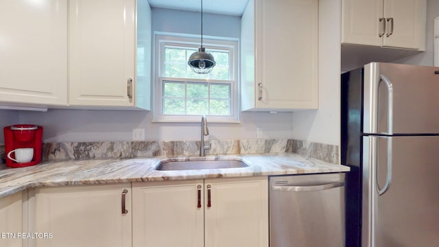 1624 Capitol Blvd, Knoxville, TN 37931 - kitchen with stainless steel appliances, a sink, white cabinets, and light stone countertops