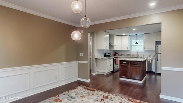 1624 Capitol Blvd, Knoxville, TN 37931 - kitchen with stainless steel appliances, dark wood-type flooring, white cabinets, crown molding, and decorative light fixtures