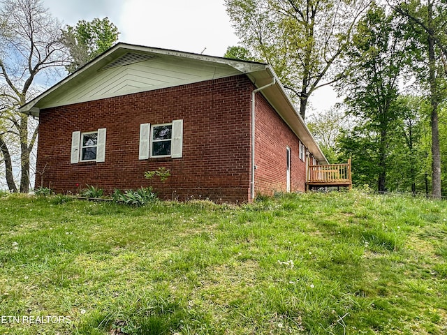 view of property exterior featuring a wooden deck and brick siding