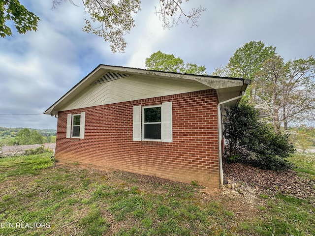 view of property exterior featuring brick siding