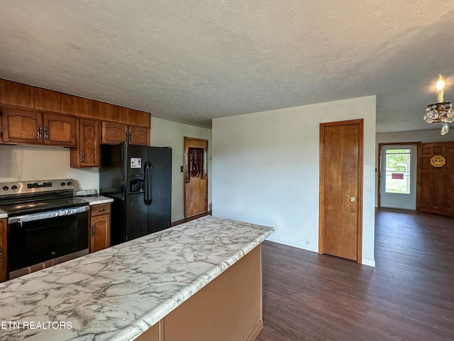 kitchen featuring dark wood-style floors, a textured ceiling, stainless steel electric range oven, black fridge with ice dispenser, and brown cabinets
