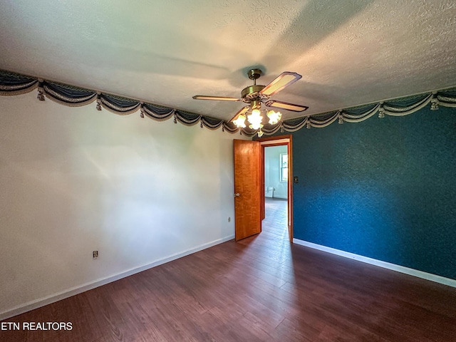 empty room with wood finished floors, a textured ceiling, baseboards, and ceiling fan
