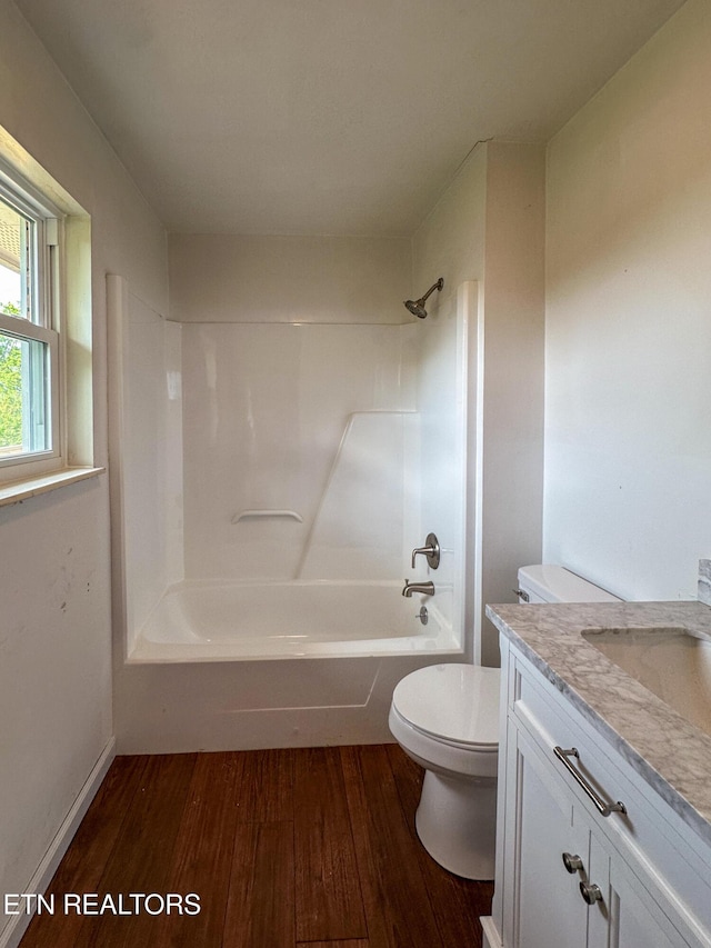 full bathroom with toilet, vanity, wood finished floors, and tub / shower combination