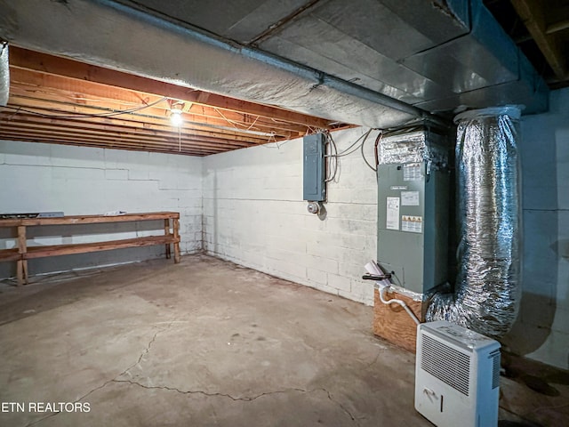 unfinished below grade area featuring heating unit and electric panel