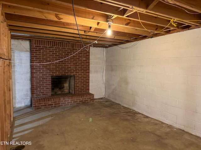 unfinished below grade area featuring a fireplace