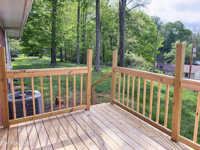 wooden deck with a lawn and central AC