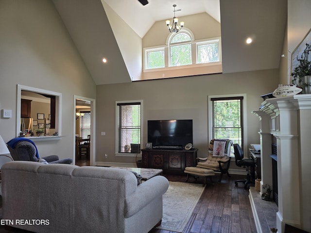 184 Danielle Ct, Harrogate, TN 37752 - living area featuring dark wood finished floors, high vaulted ceiling, an inviting chandelier, and baseboards